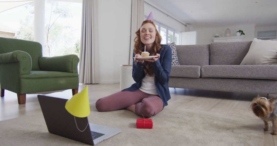 Woman Celebrating Virtual Birthday Party with Laptop and Cupcake at Home - Free Images, Stock Photos and Pictures on Pikwizard.com