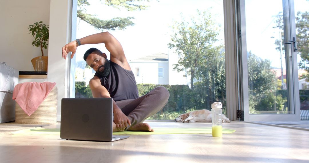 Young Man Practicing Yoga at Home with Laptop - Free Images, Stock Photos and Pictures on Pikwizard.com