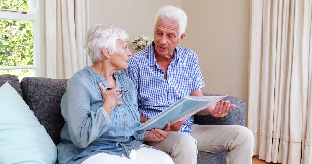 Senior Couple Reviewing Financial Documents in Living Room - Free Images, Stock Photos and Pictures on Pikwizard.com