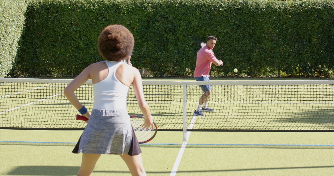 Mixed Doubles Playing Tennis Match on Sunny Day on Outdoor Court - Free Images, Stock Photos and Pictures on Pikwizard.com