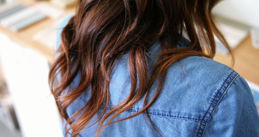 Woman with Brown Wavy Hair in Denim Jacket Indoors - Free Images, Stock Photos and Pictures on Pikwizard.com