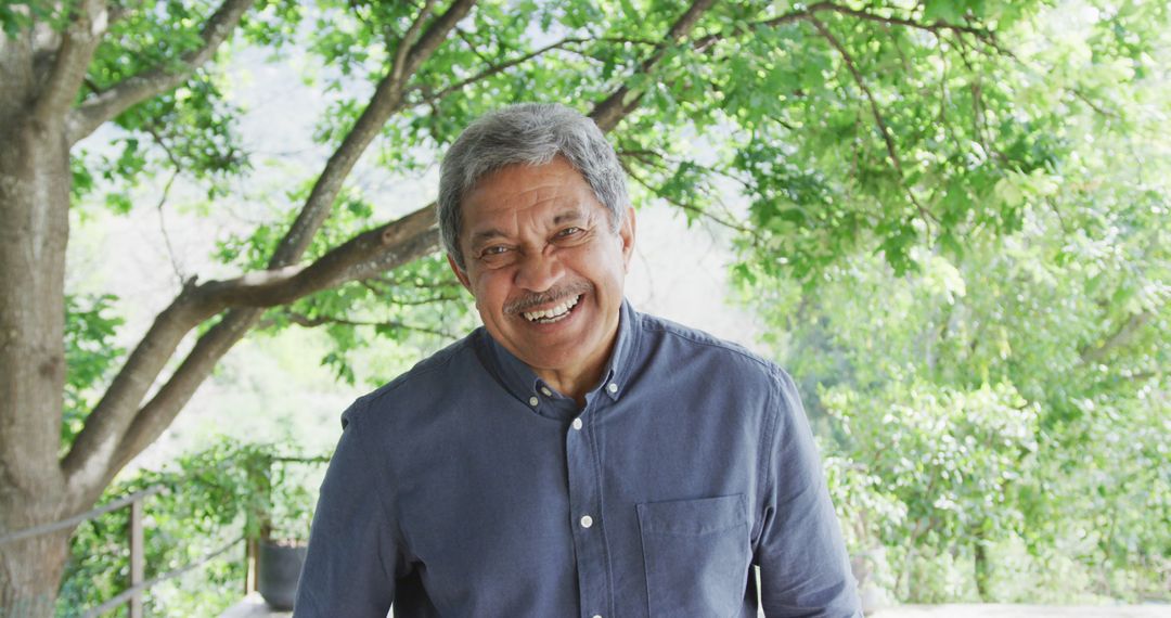 Senior Adult Man Smiling Outdoors Amidst Lush Greenery - Free Images, Stock Photos and Pictures on Pikwizard.com