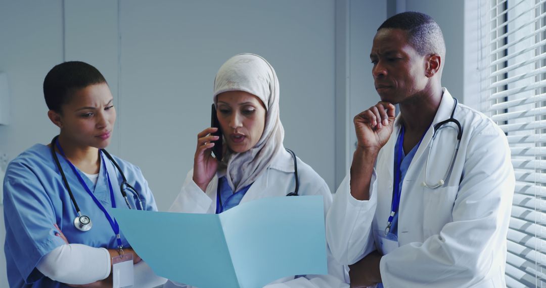 Medical Professionals Discussing Patient's File in Hospital - Free Images, Stock Photos and Pictures on Pikwizard.com