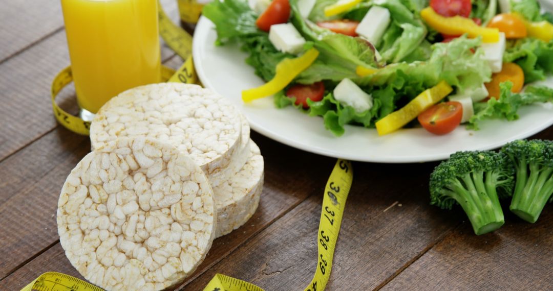 Healthy Diet Concept with Salad and Rice Cakes on Wooden Table - Free Images, Stock Photos and Pictures on Pikwizard.com