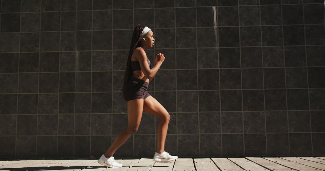 Young Woman Running Outdoors in Athletic Wear - Free Images, Stock Photos and Pictures on Pikwizard.com