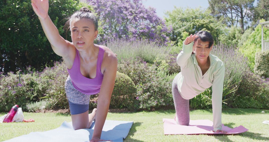 Two Women Practicing Yoga Outdoors on Sunny Day - Free Images, Stock Photos and Pictures on Pikwizard.com