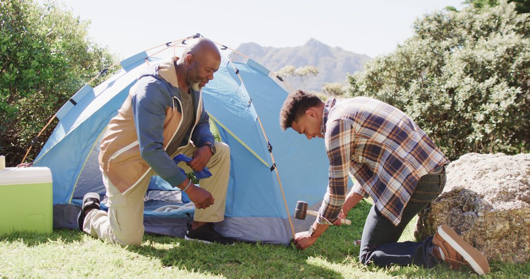 Father and Son Setting Up Tent in Scenic Outdoors - Free Images, Stock Photos and Pictures on Pikwizard.com