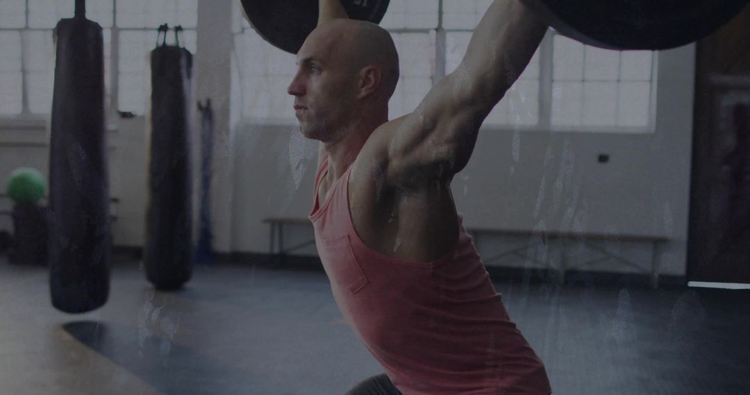 Man Practicing Olympic Lifts in Modern Gym Environment