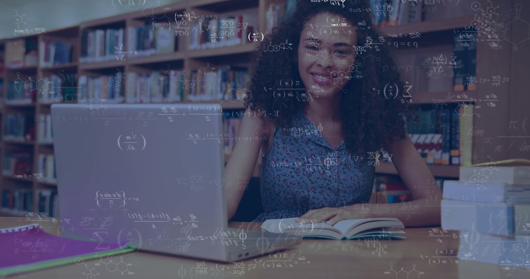 Student Engaged with Laptop and Books in Library Setting