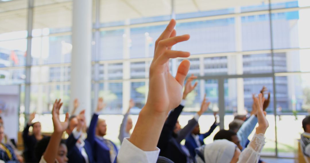 Diverse Group of People Raising Hands in Modern Office - Free Images, Stock Photos and Pictures on Pikwizard.com