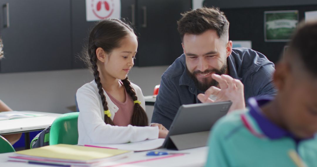 Teacher Engaging with Student Through Tablet in Classroom