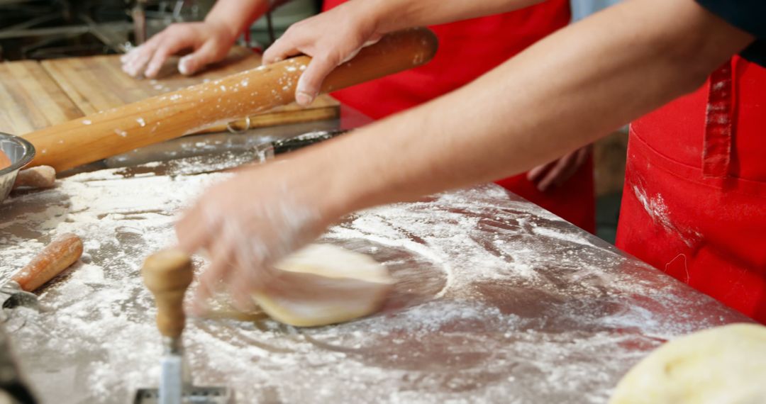 Bakers Kneading Dough in Flour-Dusted Kitchen - Free Images, Stock Photos and Pictures on Pikwizard.com