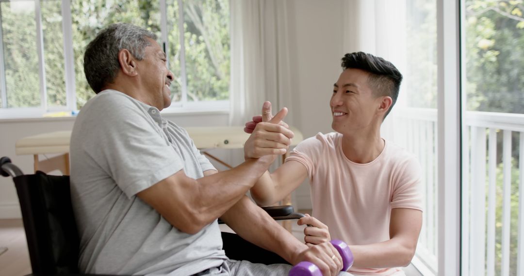 Supportive Physiotherapist Assisting Elderly Man with Exercise