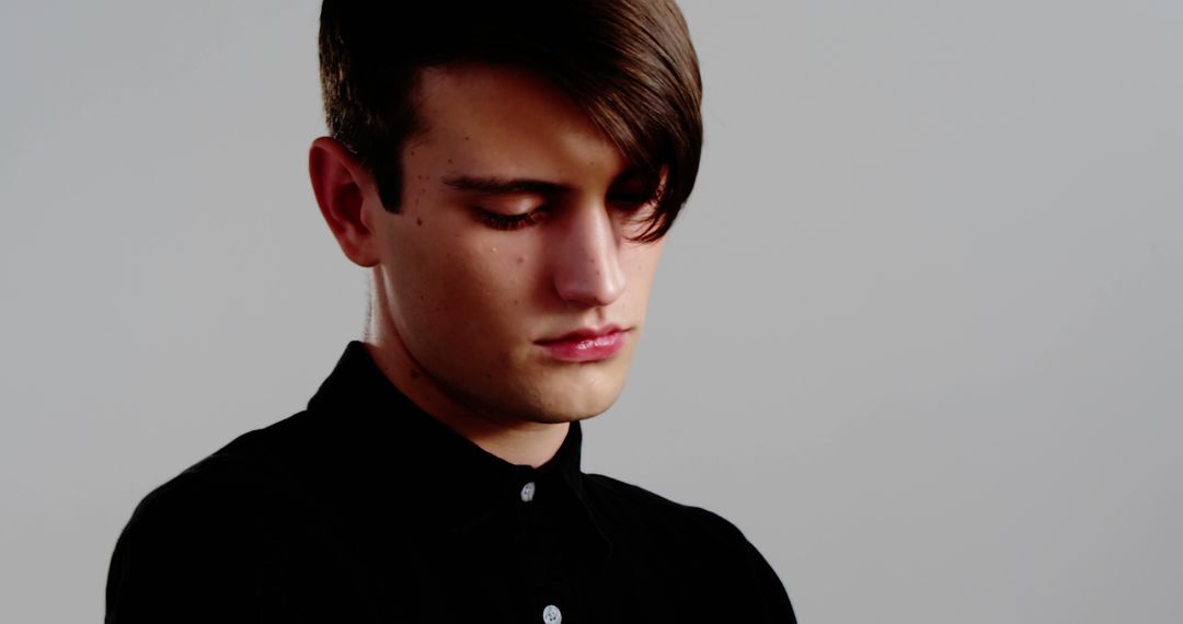 Contemplative Young Man in Dark Attire with Copy Space