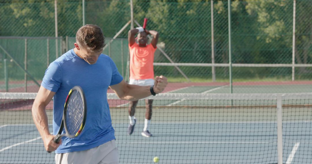 Men Playing Tennis Match Celebrating Victory on Court - Free Images, Stock Photos and Pictures on Pikwizard.com