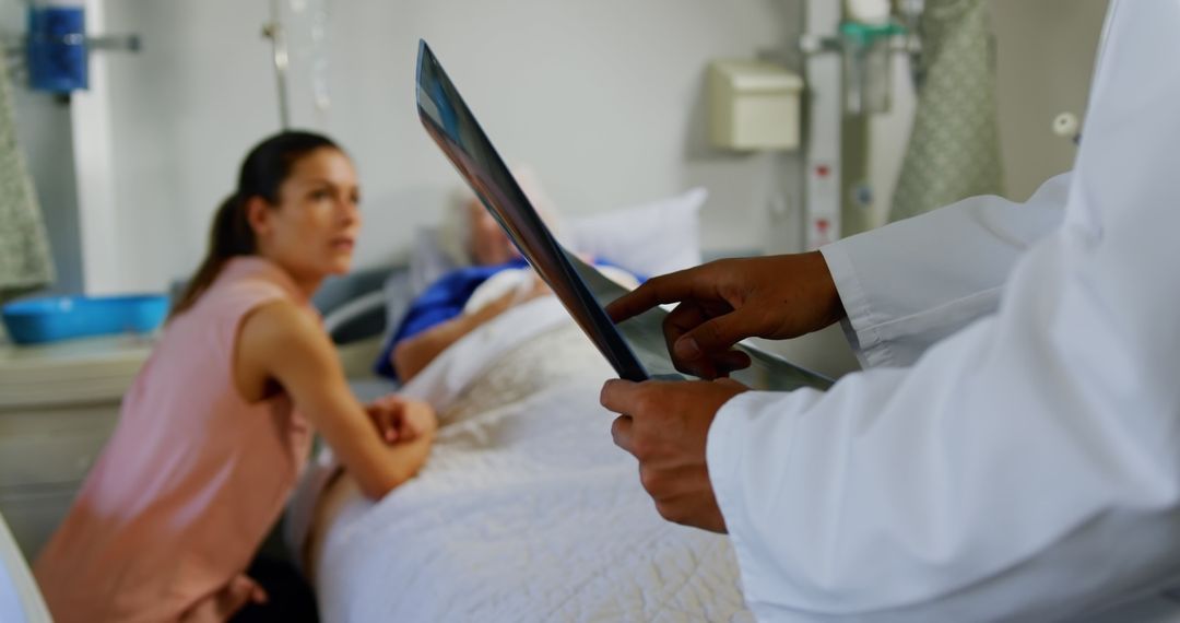 Doctor Discussing X-ray Results with Concerned Family in Hospital Room - Free Images, Stock Photos and Pictures on Pikwizard.com