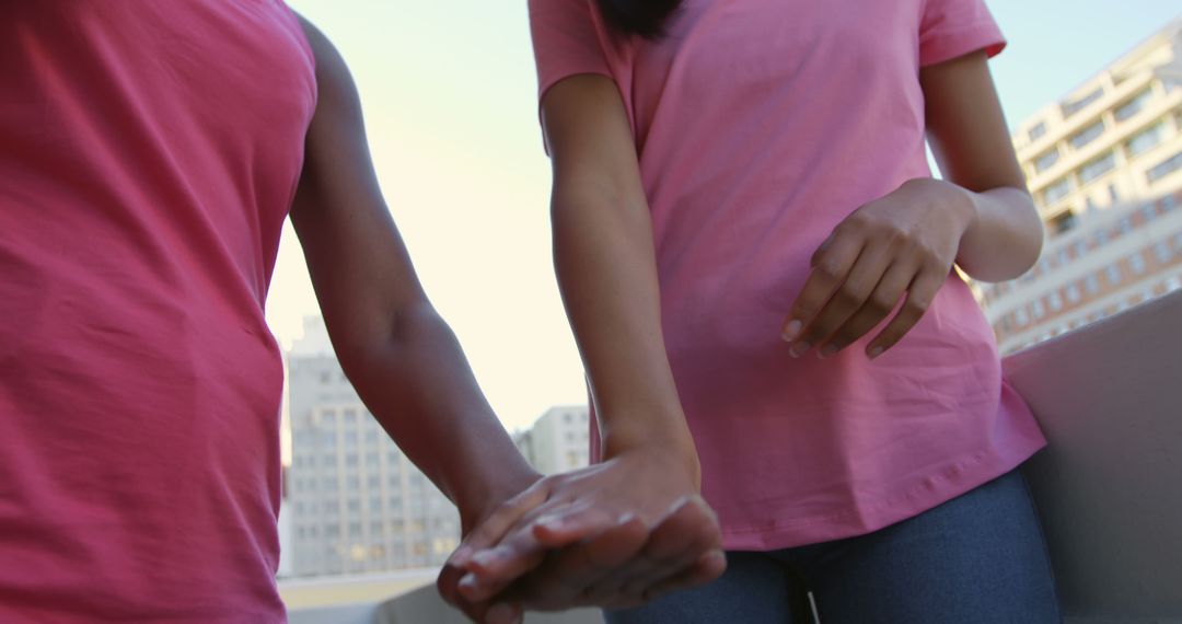 Couple Holding Hands Symbolizing Connection and Unity in Urban Setting