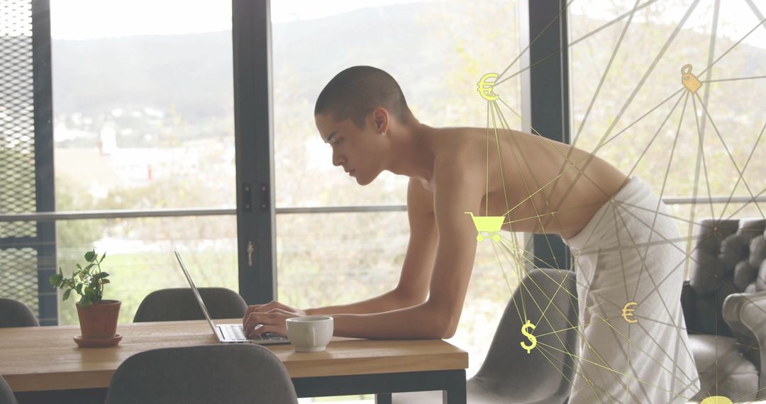 Man Wrapped in Towel Typing on Laptop in Modern Living Space