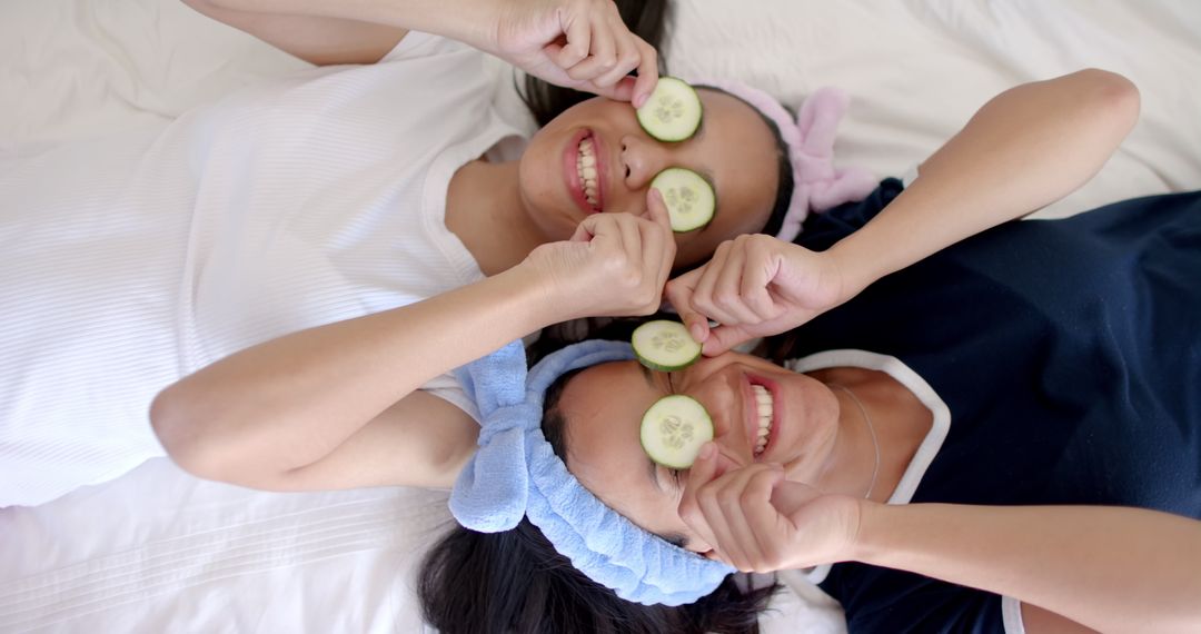Teen Friends Enjoying Fun Spa Day with Cucumber Slices