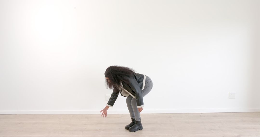 Woman Interacting with Invisible Object in Minimalist Space