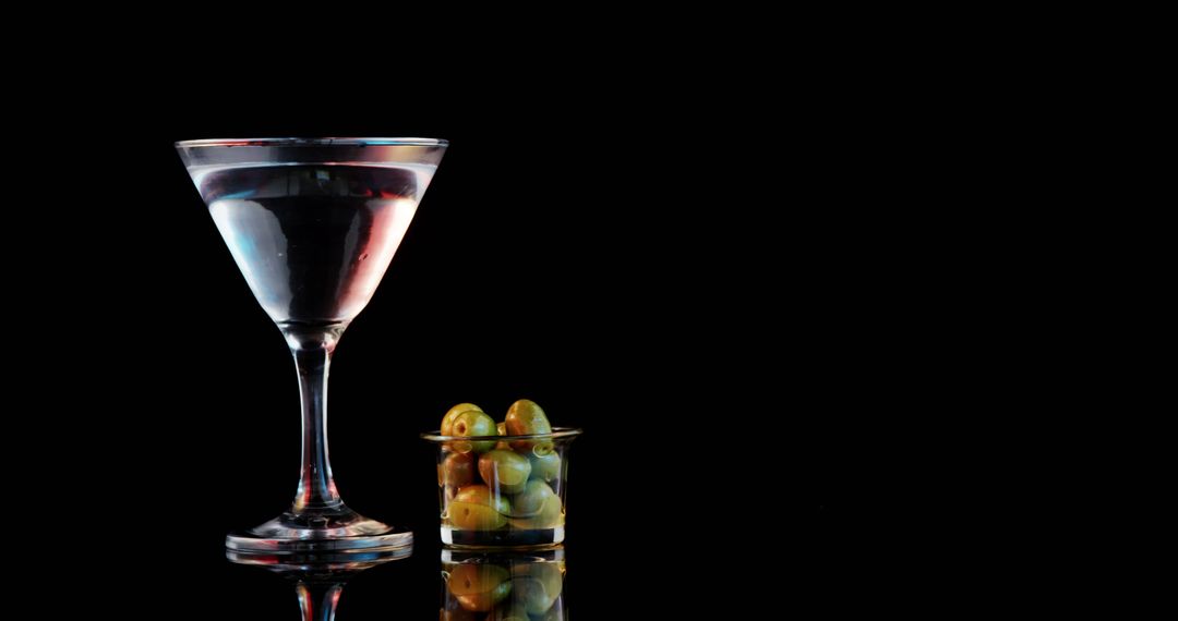 Martini Cocktail with Olives on Black Background - Free Images, Stock Photos and Pictures on Pikwizard.com