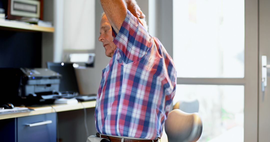 Senior Man Stretching at Home Office Desk - Free Images, Stock Photos and Pictures on Pikwizard.com