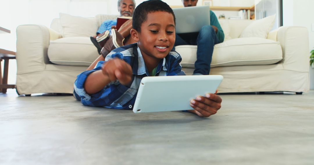 Young Boy Using Tablet in Modern Family Living Room - Free Images, Stock Photos and Pictures on Pikwizard.com