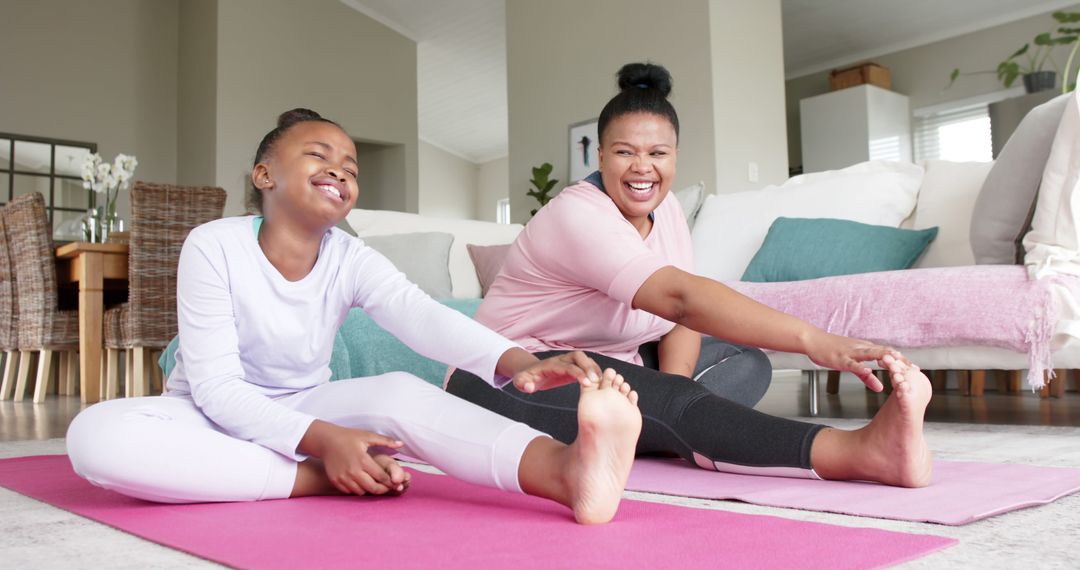 Mother and Daughter Stretching Together at Home Mats Smiling - Free Images, Stock Photos and Pictures on Pikwizard.com