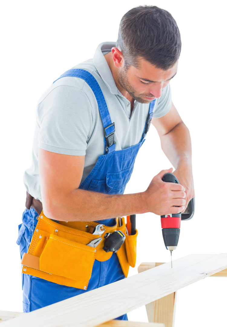 Carpenter using drill machine on wood, wearing work overalls and tool belt - Download Free Stock Images Pikwizard.com