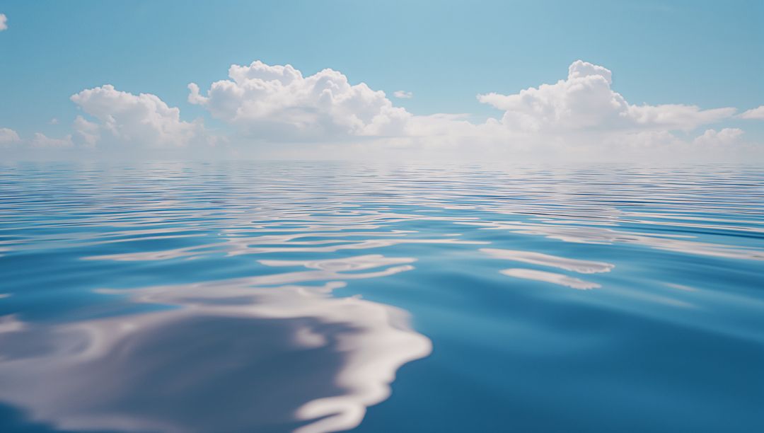 Ocean Serenity Under Clear Sky with Majestic Clouds