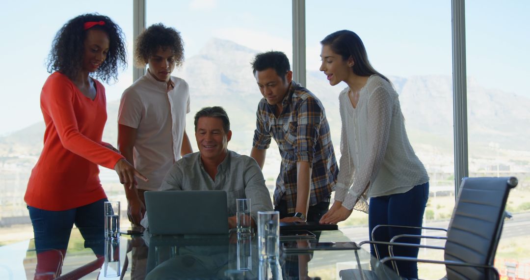 Diverse Team Collaborating on Project in Office with Laptop