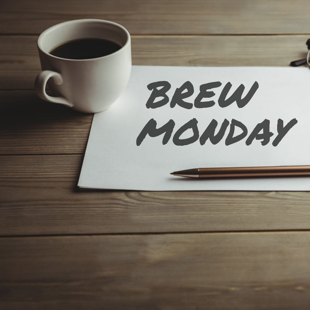 Brew Monday Motivation with Coffee and Note on Wooden Table
