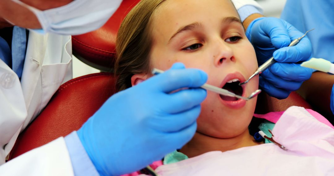 Dentist Checking Teeth of Young Girl - Free Images, Stock Photos and Pictures on Pikwizard.com