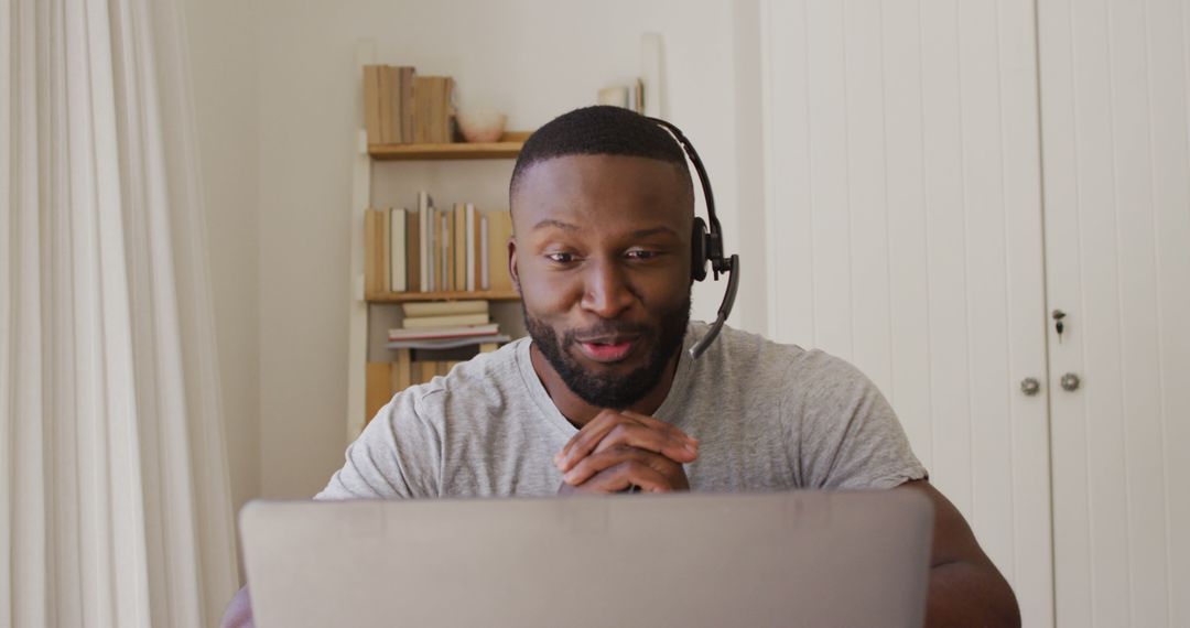 Confident African American man having video call with headset - Free Images, Stock Photos and Pictures on Pikwizard.com