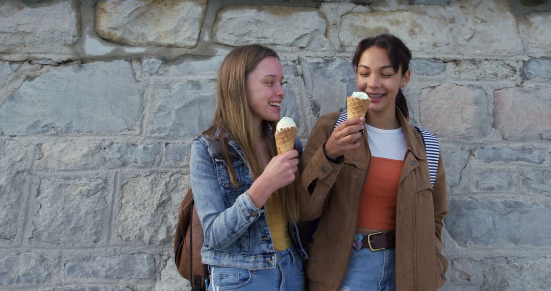 Two Friendly Young Women Enjoying Ice Cream Together - Free Images, Stock Photos and Pictures on Pikwizard.com