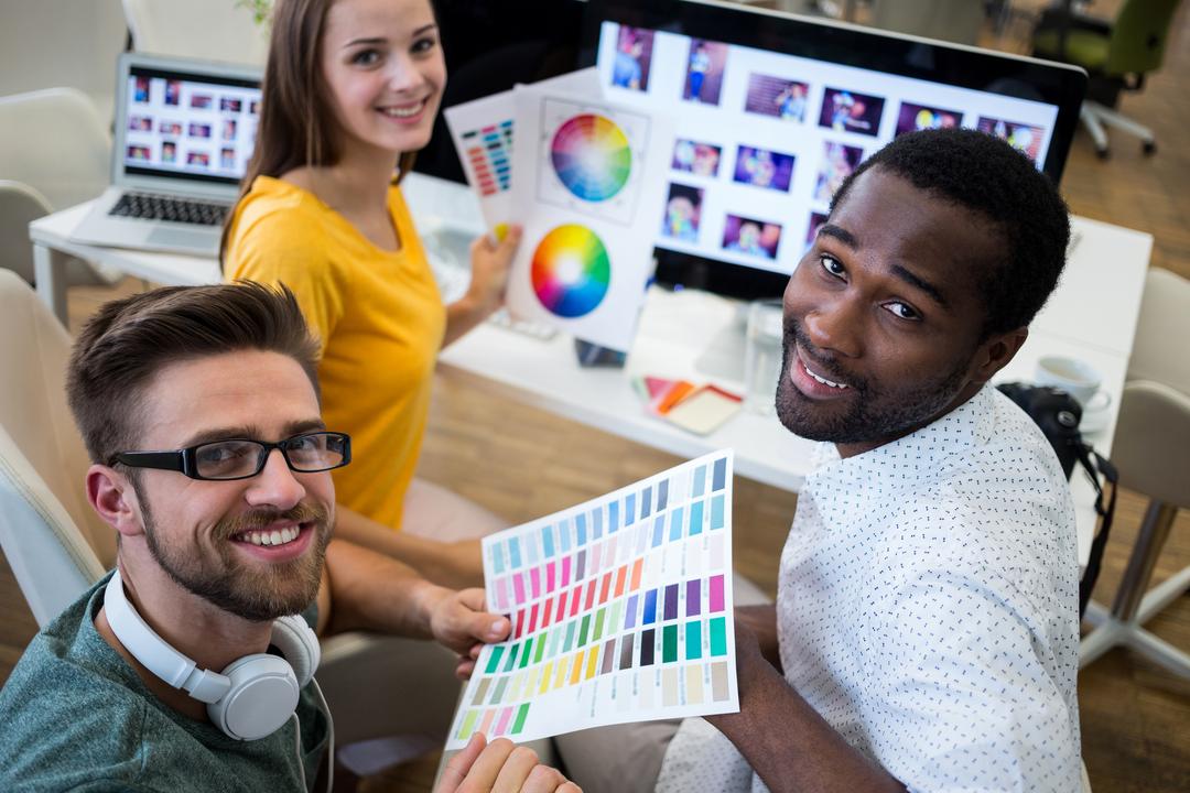 Group of graphic designers holding color chart - Free Images, Stock Photos and Pictures on Pikwizard.com