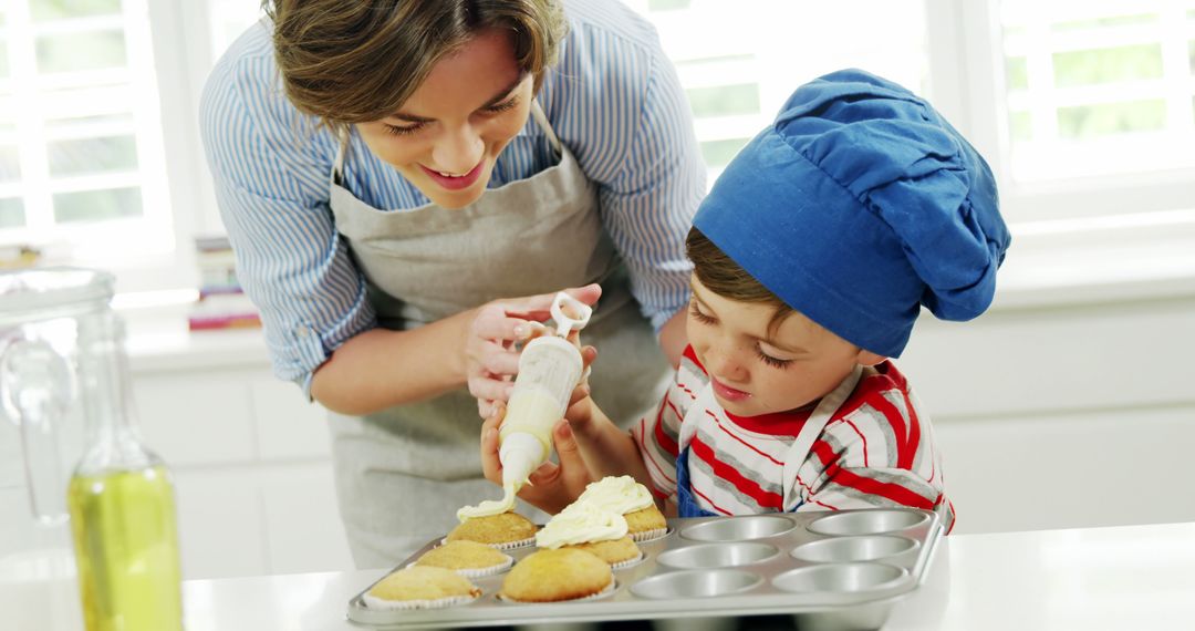 Mother And Son Baking Cupcakes In Modern Kitchen - Free Images, Stock Photos and Pictures on Pikwizard.com