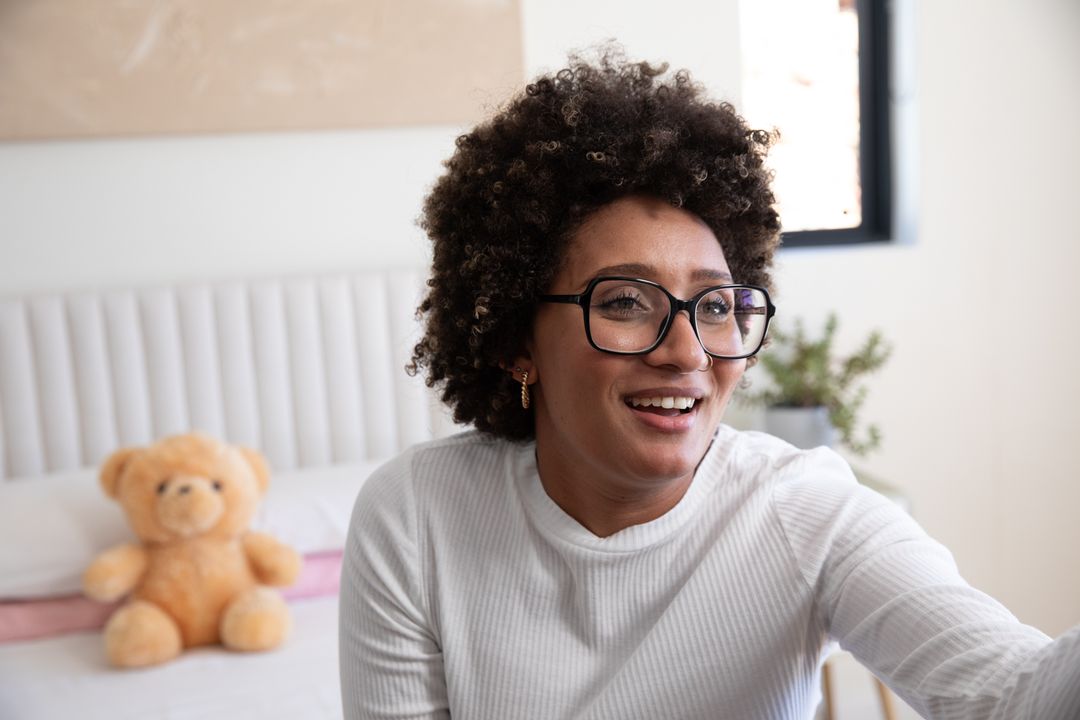 Joyful Woman Relaxing at Home, Connecting with Comfort