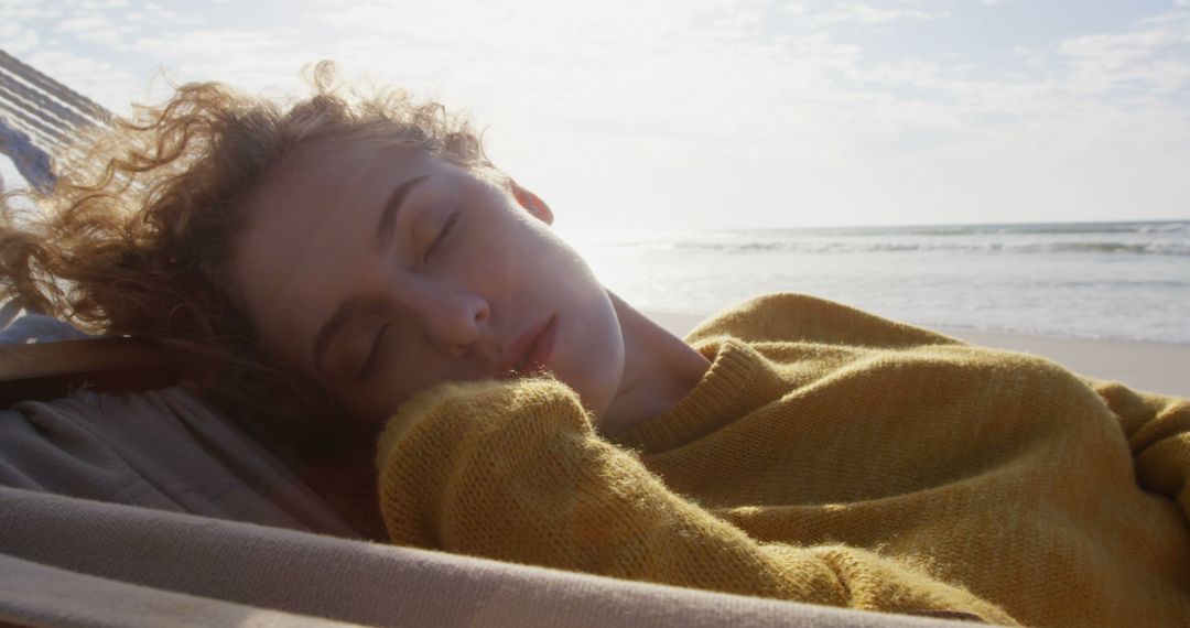 Woman Wearing Yellow Sweater Relaxing on Beach - Free Images, Stock Photos and Pictures on Pikwizard.com