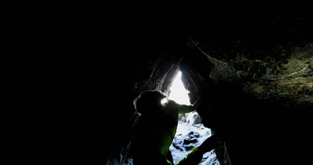 Person Exploring Dark Cave with Headlamp Adventure Background - Free Images, Stock Photos and Pictures on Pikwizard.com