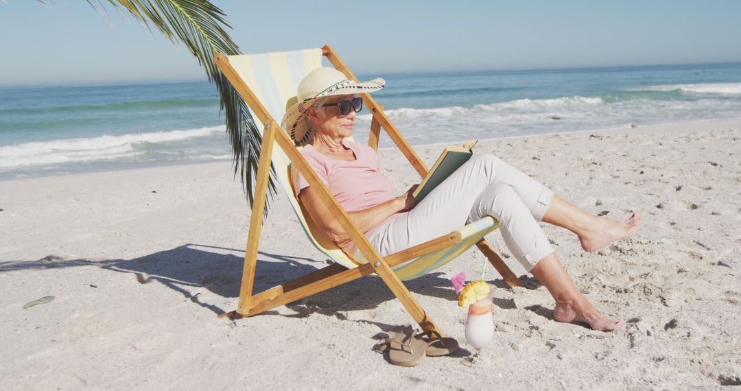 Senior Woman Relaxing on Beach Chair Reading Books by Sea Shore - Free Images, Stock Photos and Pictures on Pikwizard.com