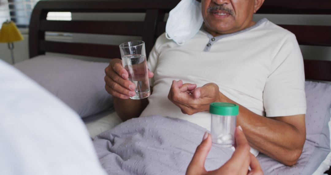 Elderly Man Taking Medication in Bed with Assistance - Free Images, Stock Photos and Pictures on Pikwizard.com
