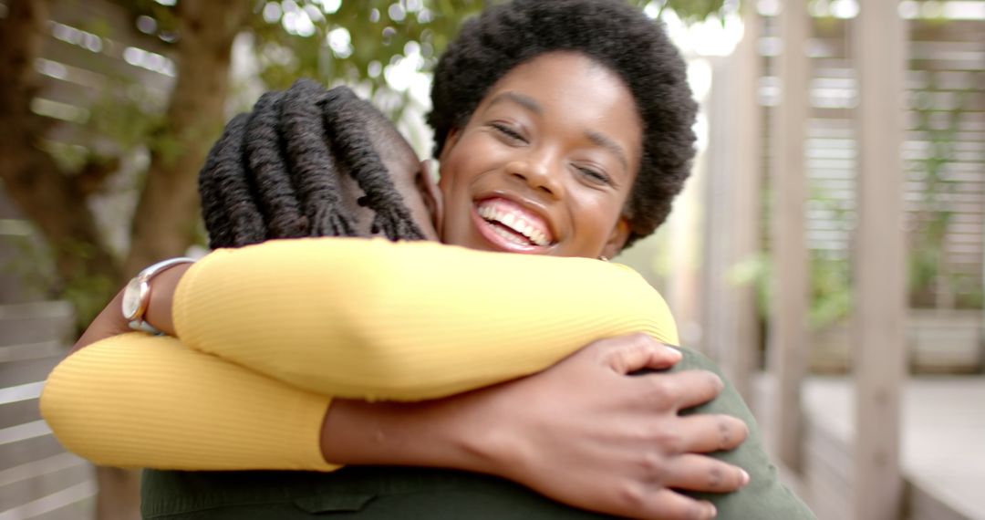 Joyful Hugging with Friends in Sunlit Garden Walkway