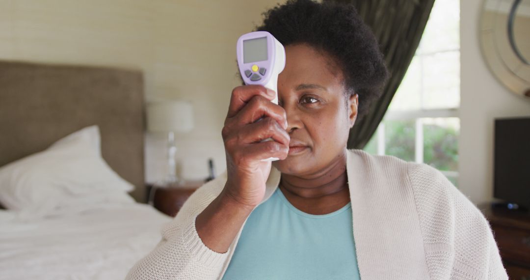 Woman Measuring Temperature with Digital Thermometer at Home - Free Images, Stock Photos and Pictures on Pikwizard.com