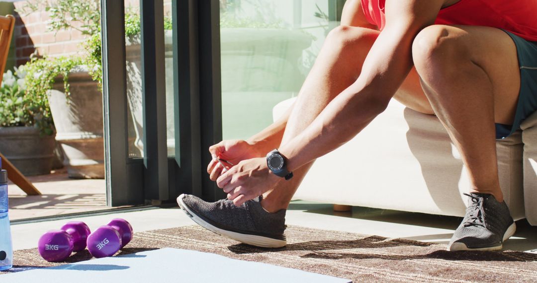 Man Preparing for Home Workout by Tying Shoe Laces