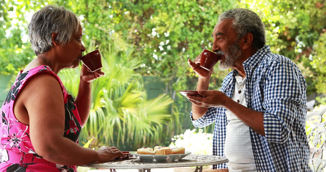 Senior couple enjoying coffee together in backyard patio - Free Images, Stock Photos and Pictures on Pikwizard.com