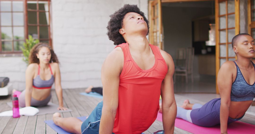 Group Practicing Yoga Outdoors in Relaxing Environment