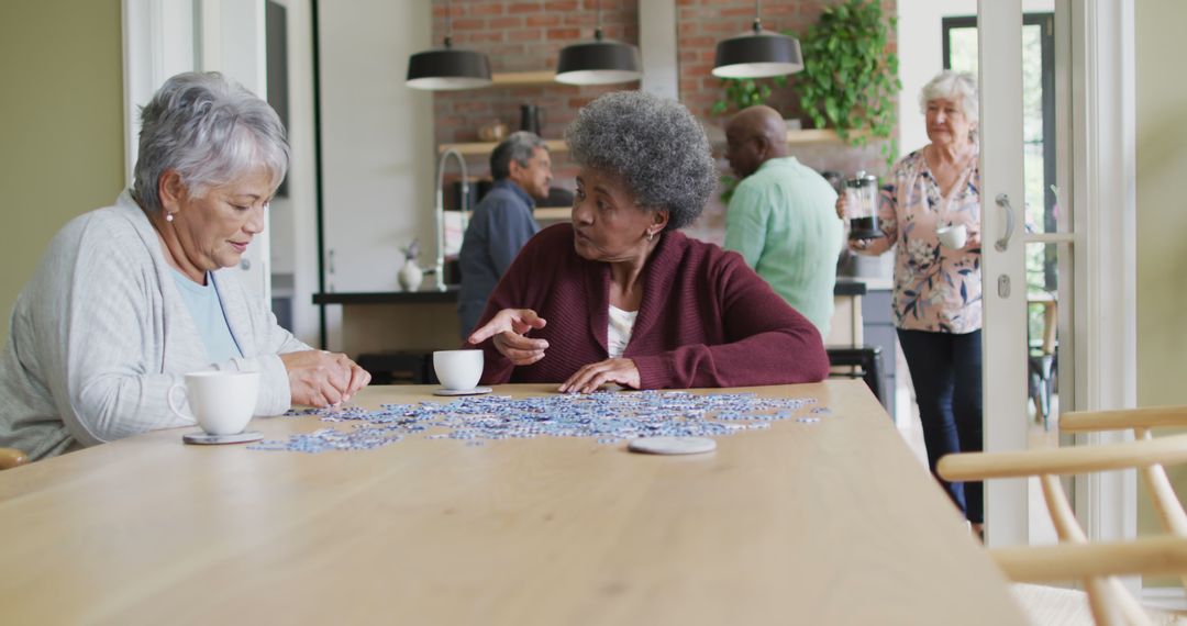 Senior Friends Enjoying a Puzzle and Coffee in Cozy Community Center - Free Images, Stock Photos and Pictures on Pikwizard.com