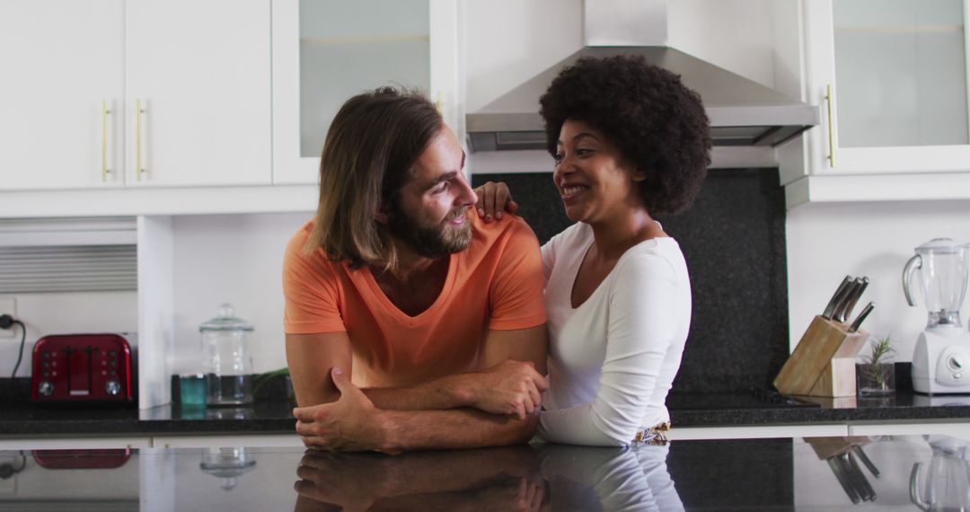 Portrait of biracial couple smiling in the kitchen at home - Free Images, Stock Photos and Pictures on Pikwizard.com