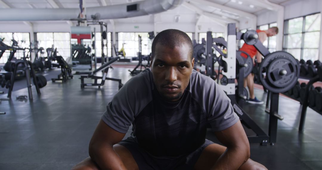 Focused Athlete Sitting on Gym Floor After Intense Workout - Free Images, Stock Photos and Pictures on Pikwizard.com